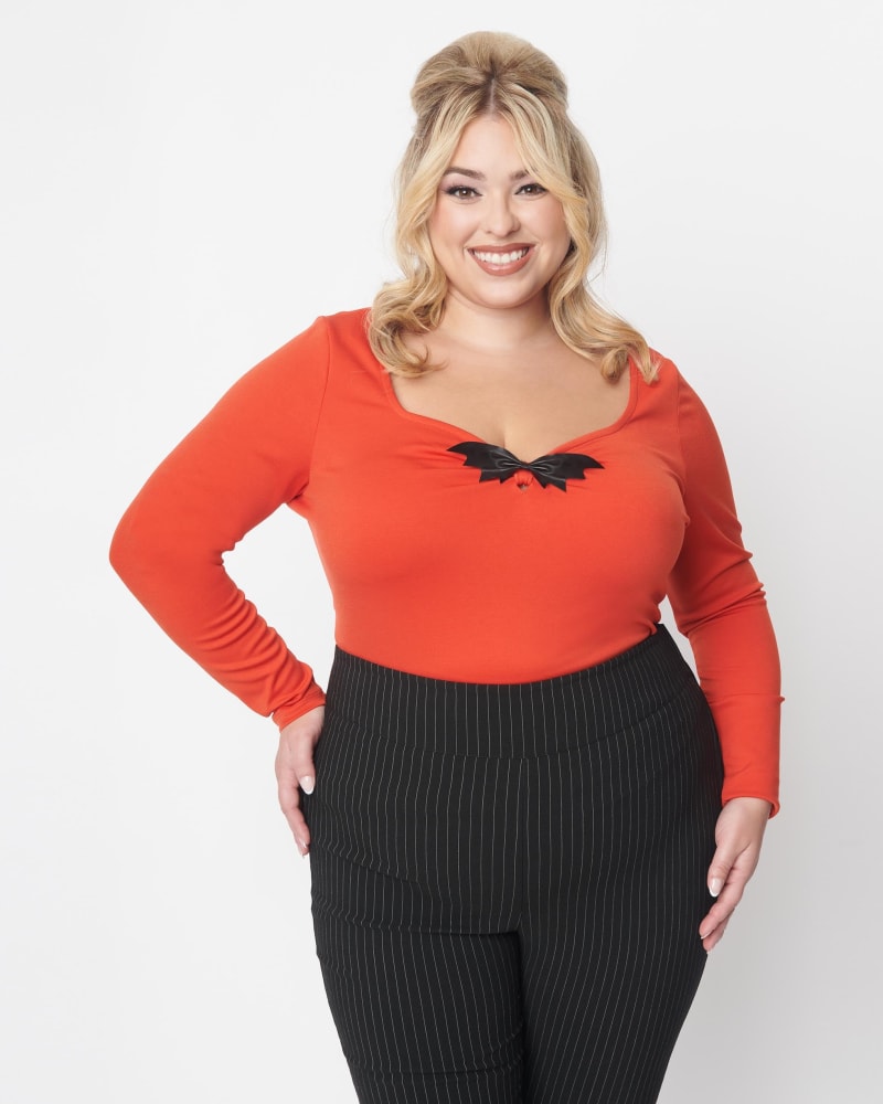 Front of a model wearing a size 5X Unique Vintage Orange & Black Bat Bow Long Sleeve Top in Orange by Unique Vintage. | dia_product_style_image_id:301866